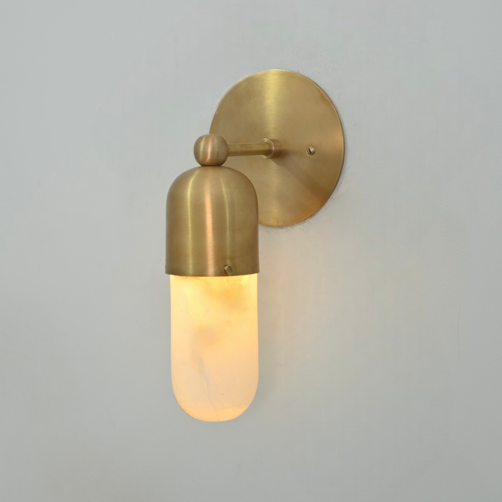 Brass and alabaster wall sconce for hallway in a warm lighting 
