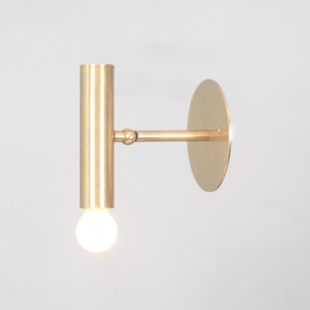 Adjustable brass globe sconce with a pure handmade raw brass finish designed by LightCove 