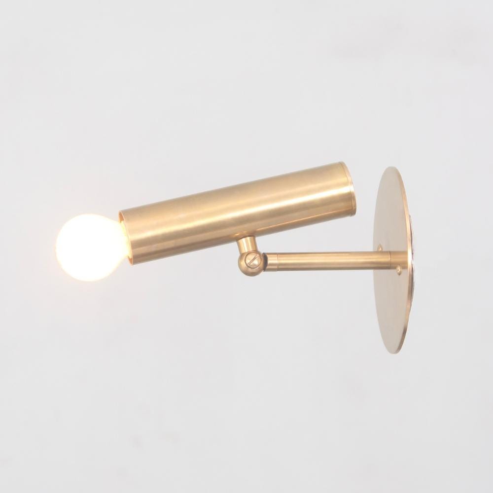 Mid Century Modern italian articulable wall lamp with a handcraft brass metal finish and a minimalistic glass globe 