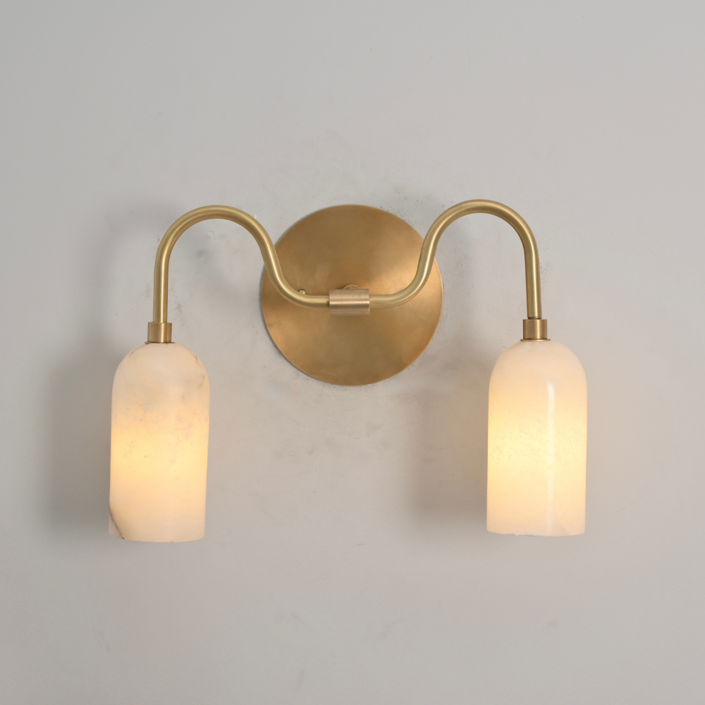 Gold wall sconce with two light bulbs on a gray background