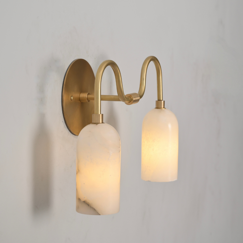 Handmade alabaster and brass wall sconce with elegant curved silhouette