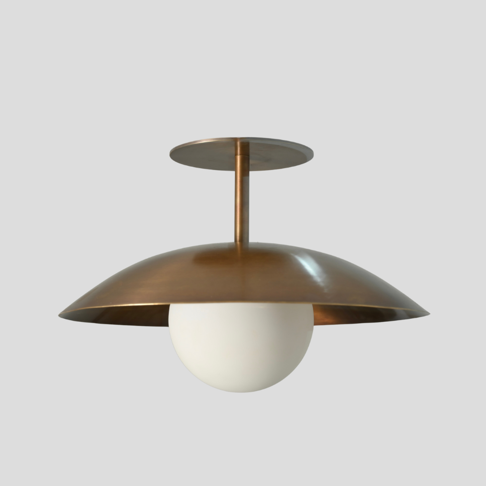 Mid century brass globe flush mount on a gray background designed by LightCove 