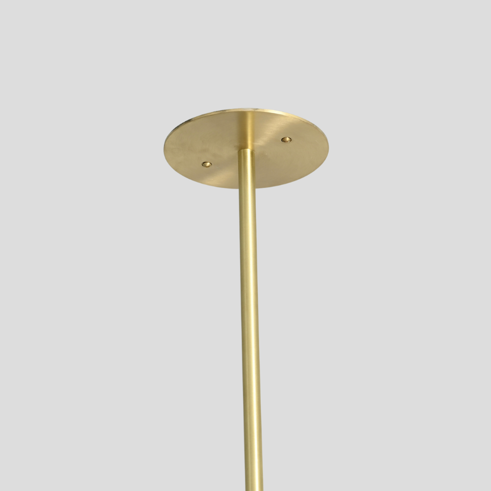 Close up on the raw brass finish of the vertical rod of modern ceiling light by LightCove 