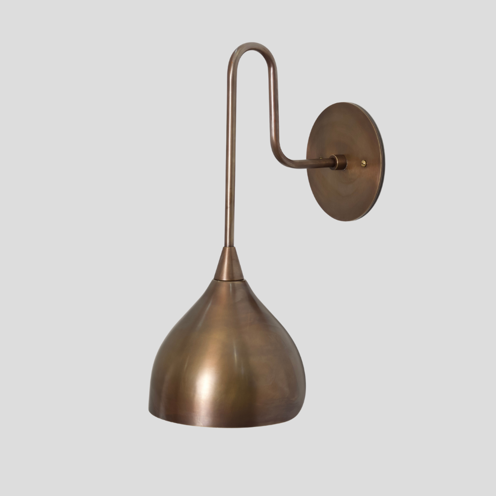 Brass wall sconce on a light gray background in a mid century design designed By LightCove 