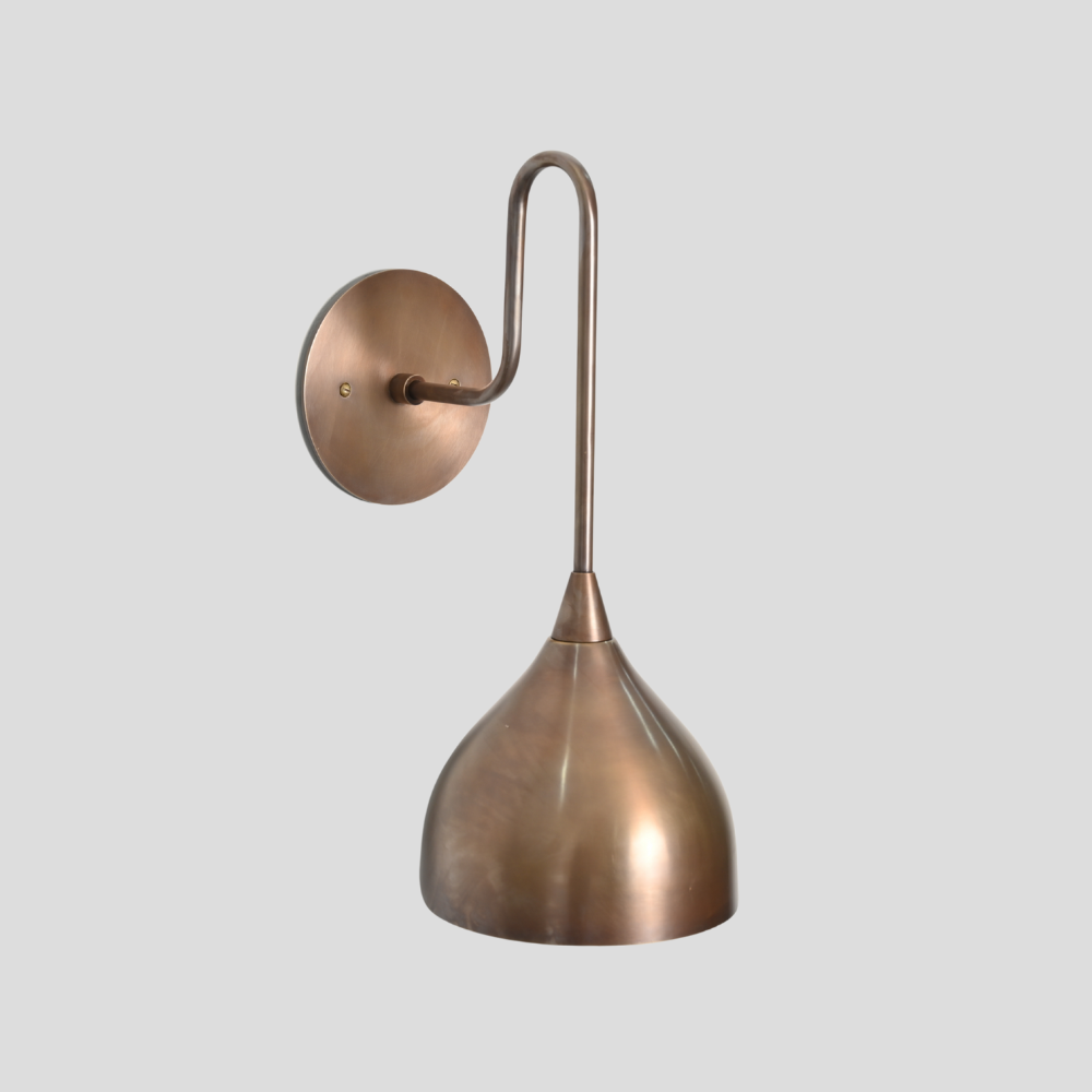 Modern wall light in a pure handcrafted brass finish 