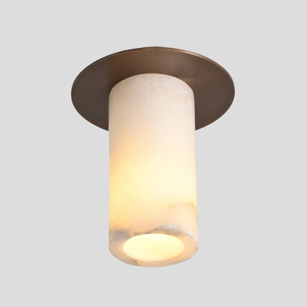 Ceiling light fixture with bronze finish and white marble cylindrical shade on a gray background