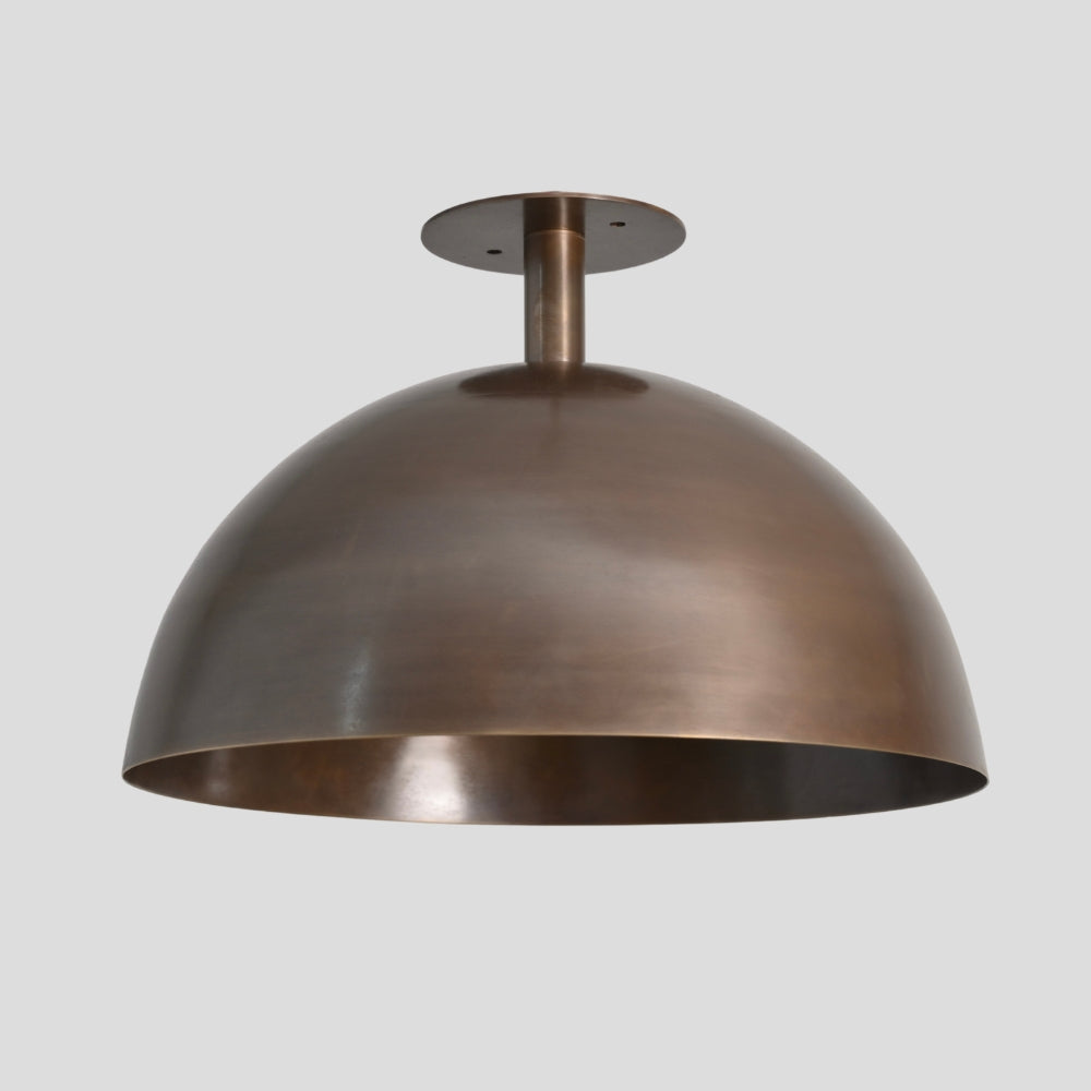 handcrafted brass dome semi flush mount ceiling light on a gray background 