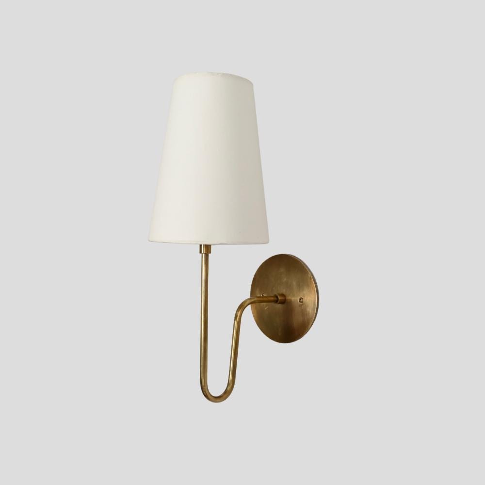 Handcrafted brass wall sconce with a mid century linen shade 