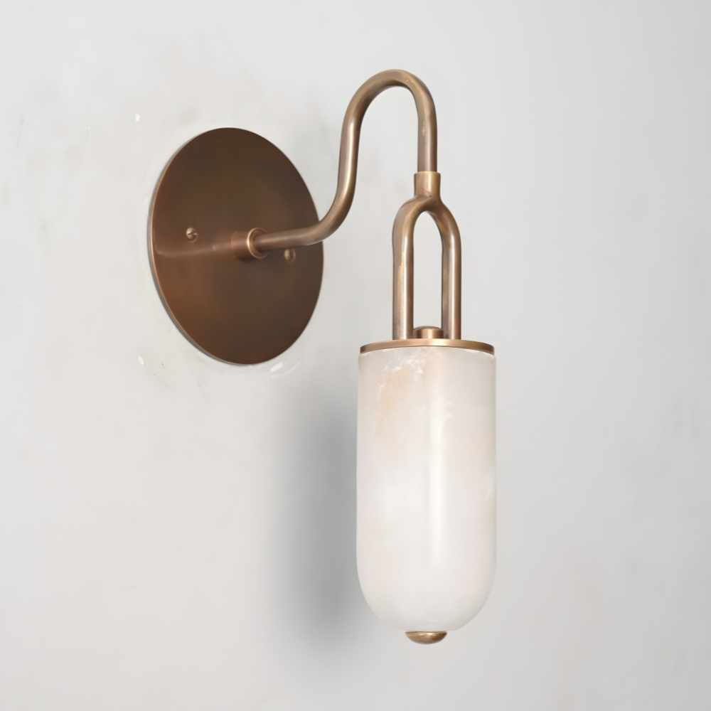 Brass wall sconce with natural alabaster shade glowing warm light