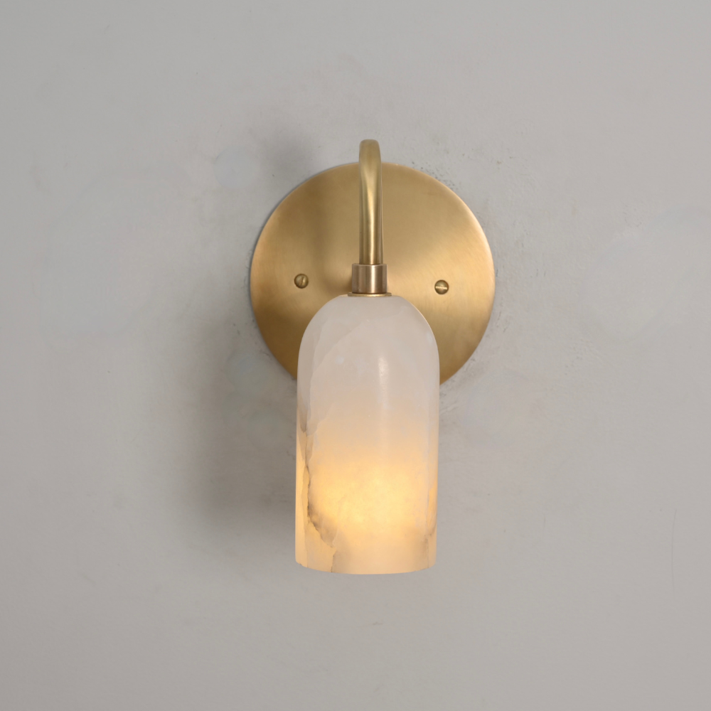 Curved brass arm wall lamp with natural alabaster diffuser