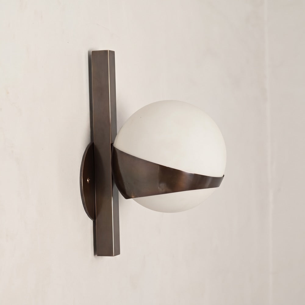 Handmade antique brass globe wall lamp, detail of the brass band and square stem