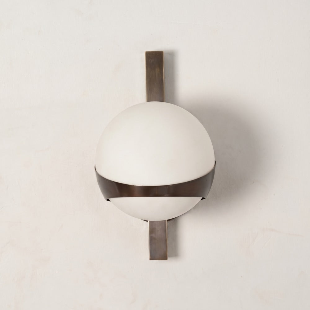 Brass banded globe wall sconce with an opal glass globe held by an antique brass band, front view
