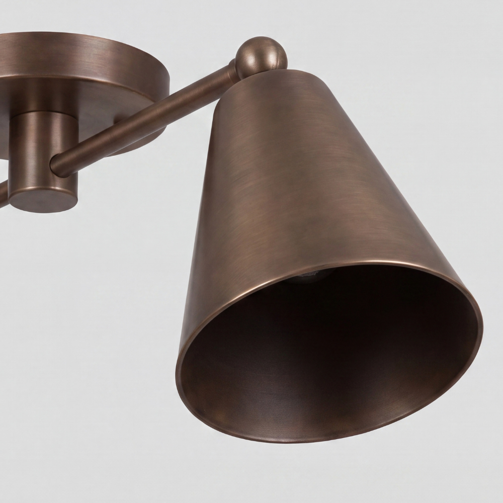 Close-up detail view of Double Brass Cone Shade Flush Mount - Adjustable Ceiling Light showing angled shade, brass connecting arm with spherical finial, and circular canopy.