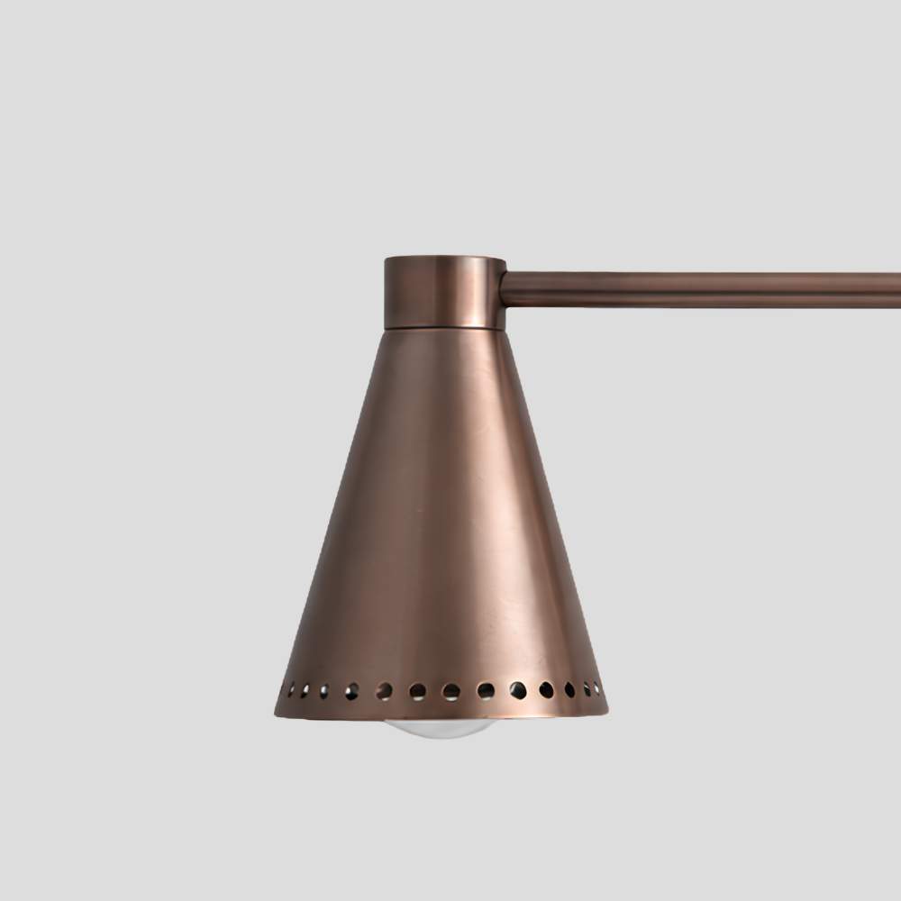 Close-up of Double Perforated Brass Cone Sconce - Mid Century Vanity Light showing perforated cone shade and horizontal bar arm detail.