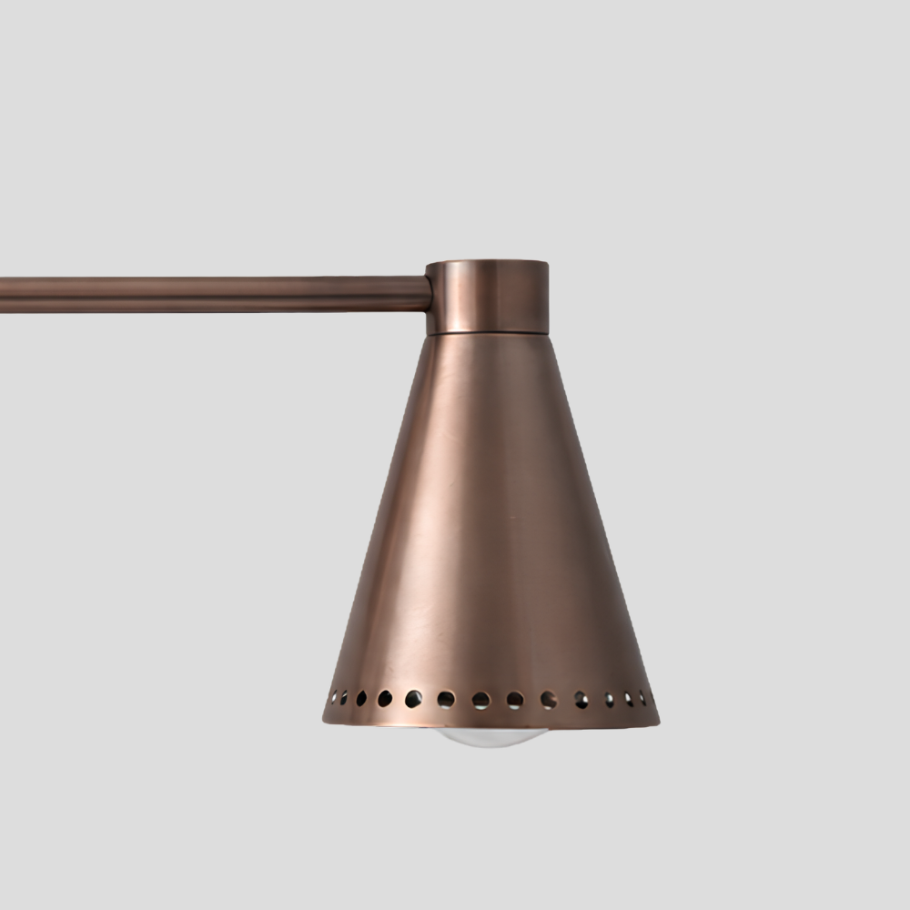 Close-up of Double Perforated Brass Cone Sconce - Mid Century Vanity Light showing perforated cone shade edge and horizontal bar arm detail.