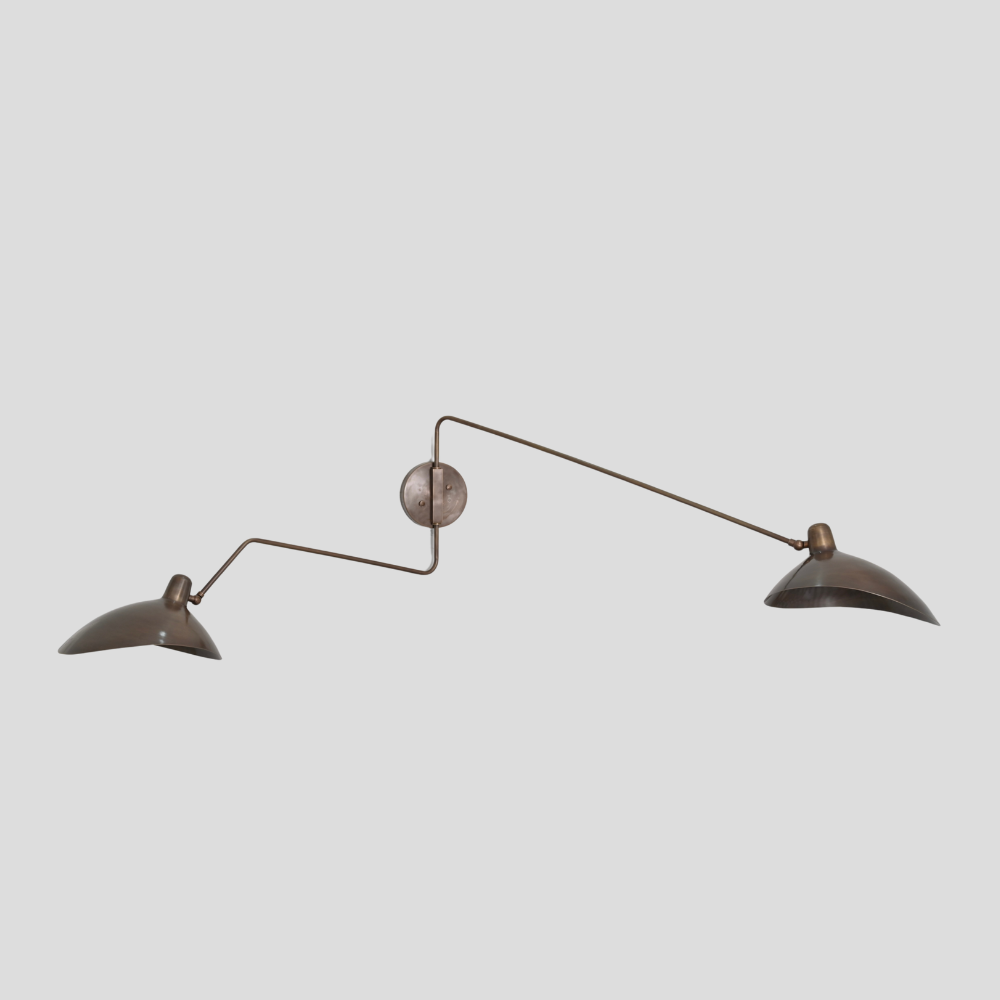 Double articulable wall light handcrafted in a pure antique brass finish inspired by mid century design 
