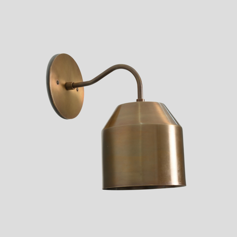 Italian Curved Brass wall sconce on a light gray background