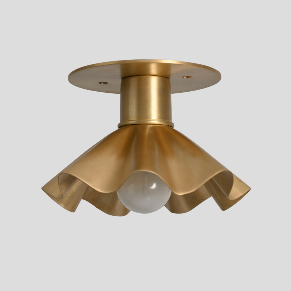 Modern raw brass flush mount with a petal shade for any interior design 