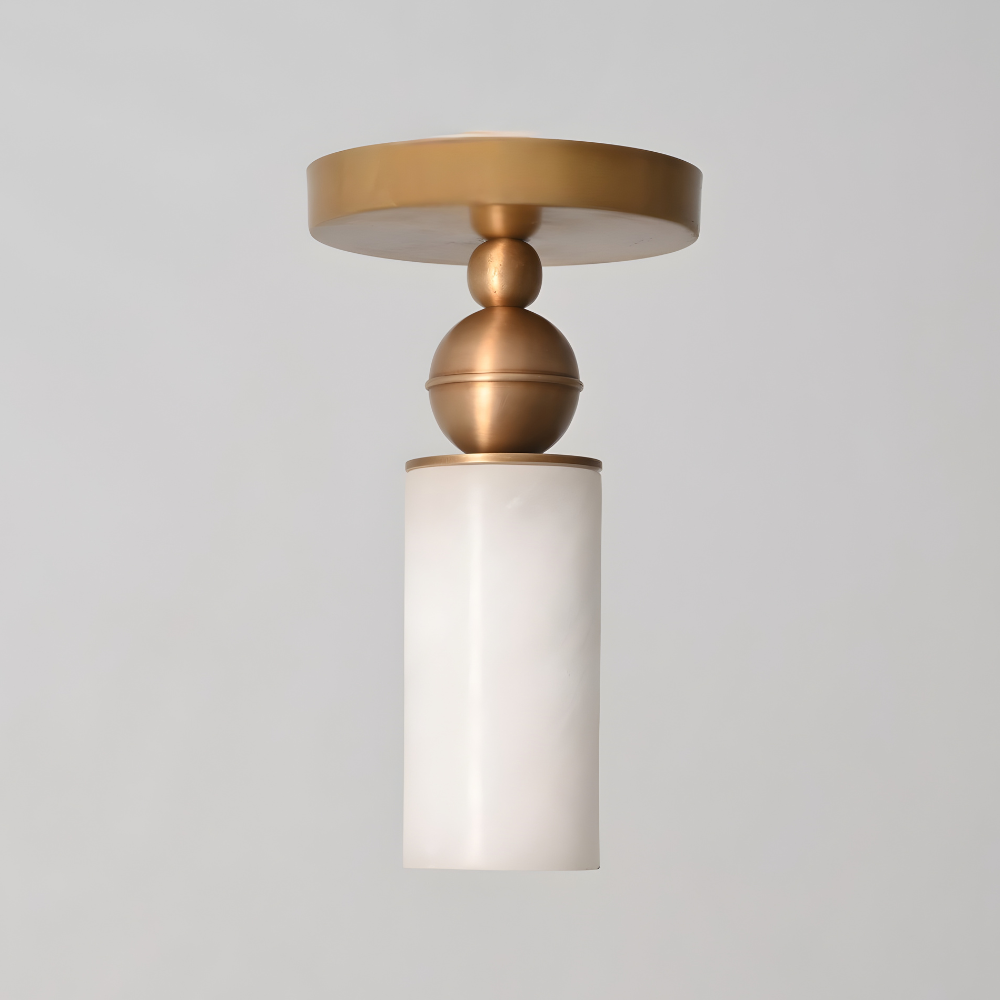 Minimalist alabaster cylinder flush mount light with brass detailing