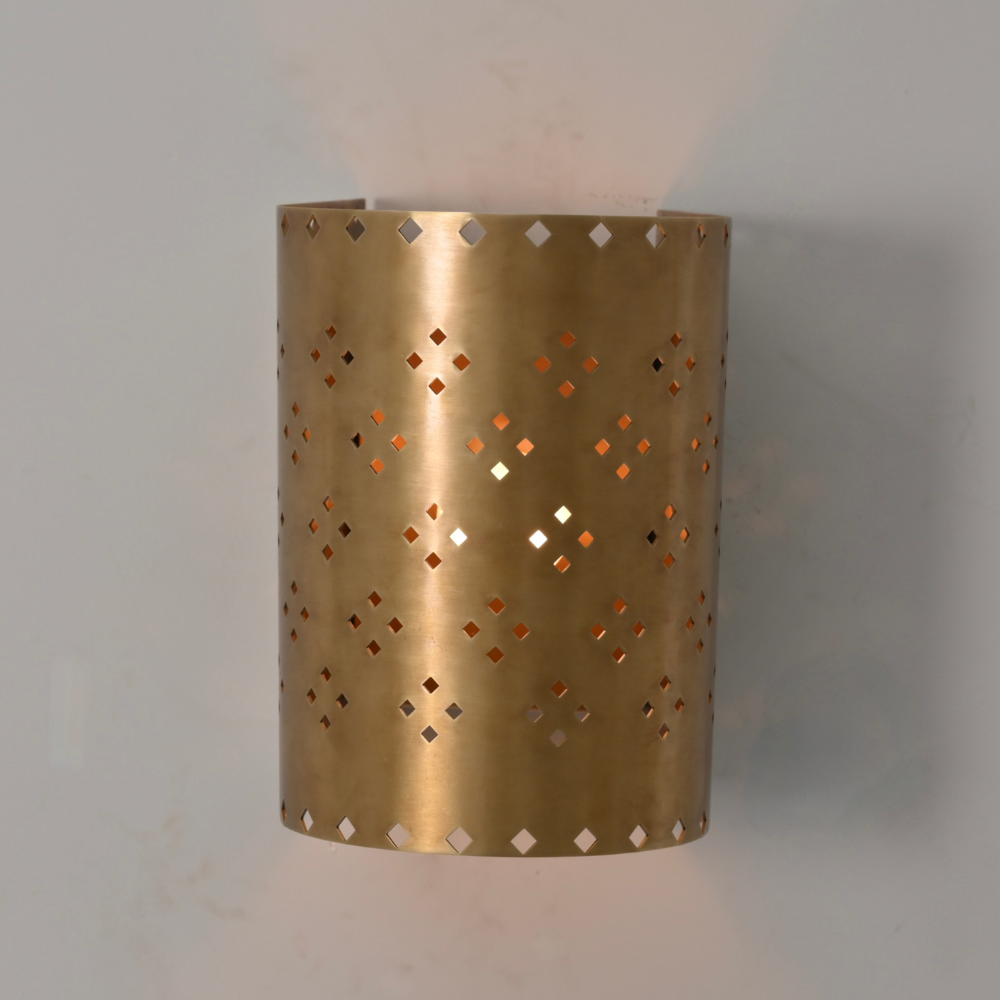 Ambient wall lighting in perforated brass finish