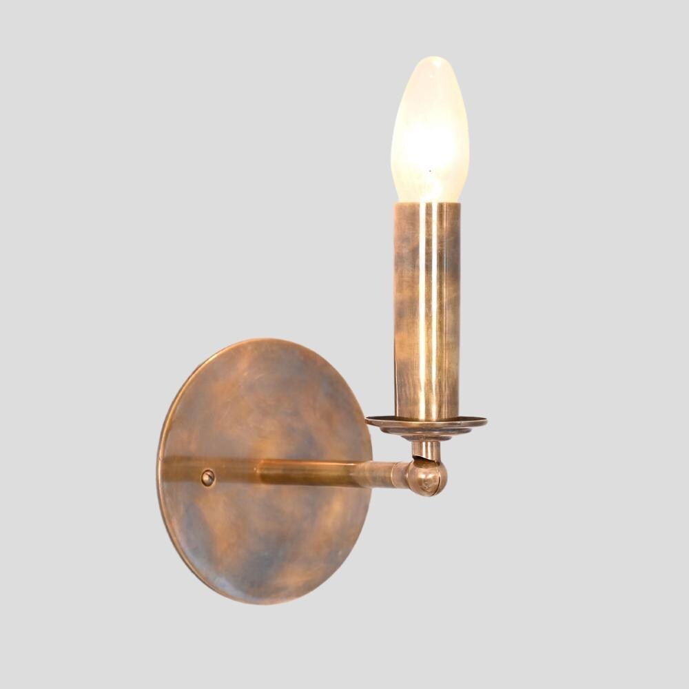 A vintage italian brass adjustable arm sconce on a gray background. 