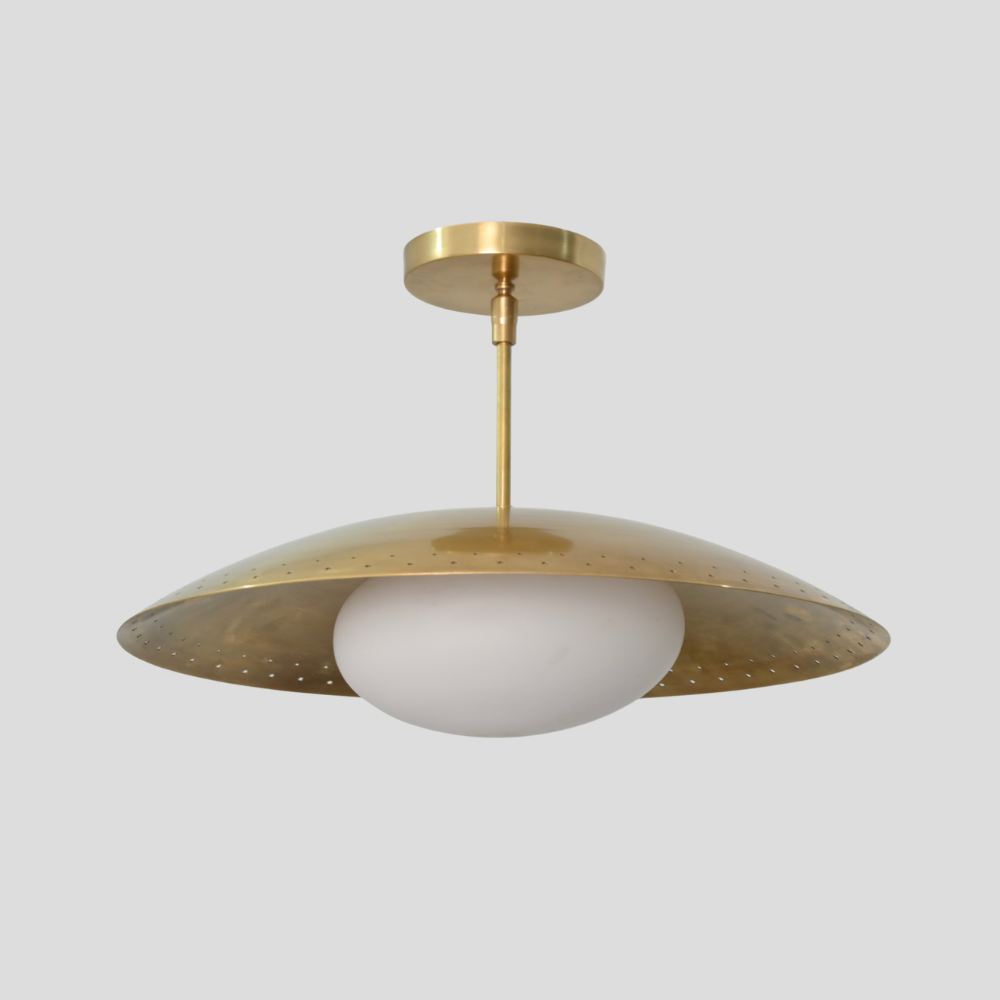 Perforated Brass Dome Ceiling Light - Glass Globe Pendant with perforated dome shade, white glass globe, brass cylindrical stem, circular brass canopy, and mid-century modern design.