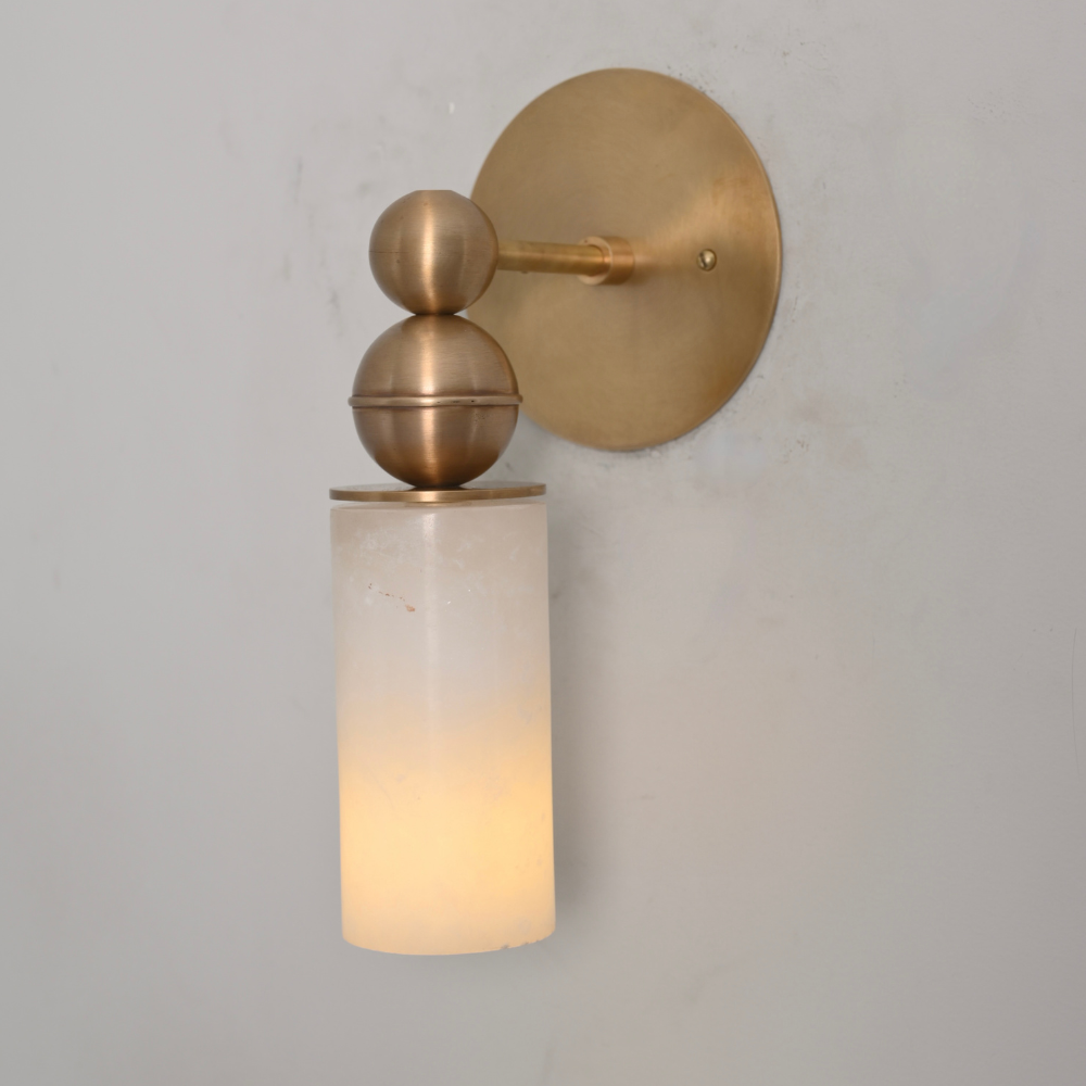 Handmade alabaster wall sconce with sculptural brass sphere detail