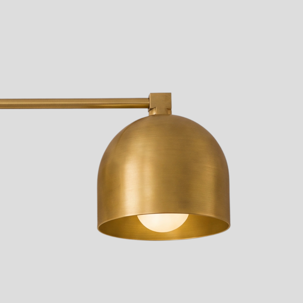 Close-up detail view of Triple Brass Dome Sconce - Mid Century Linear Arm Vanity Light showing dome shade, open bottom design and connecting arm.
