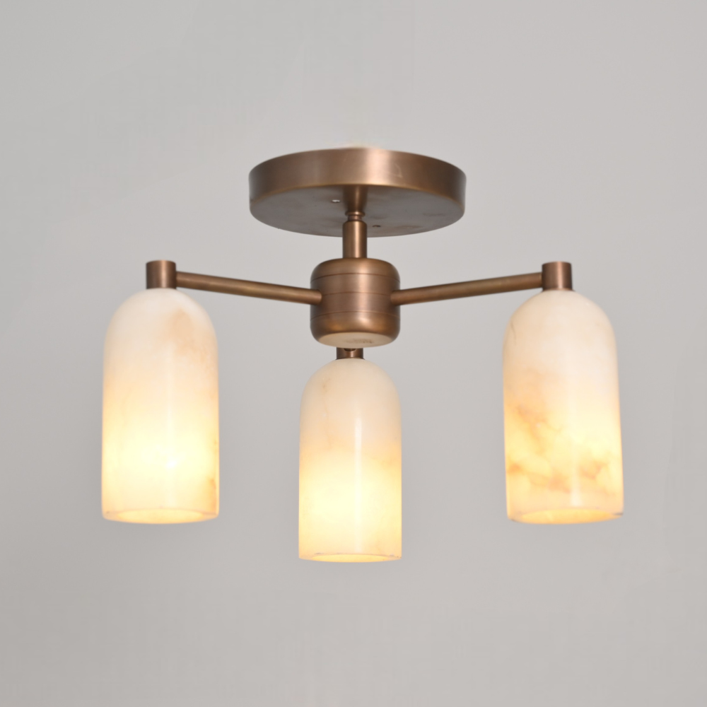 Ceiling light fixture with three alabaster shades on a gray background