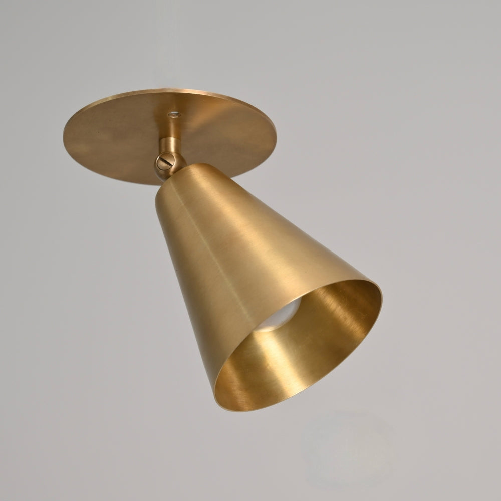 Gold ceiling light fixture on a gray background
