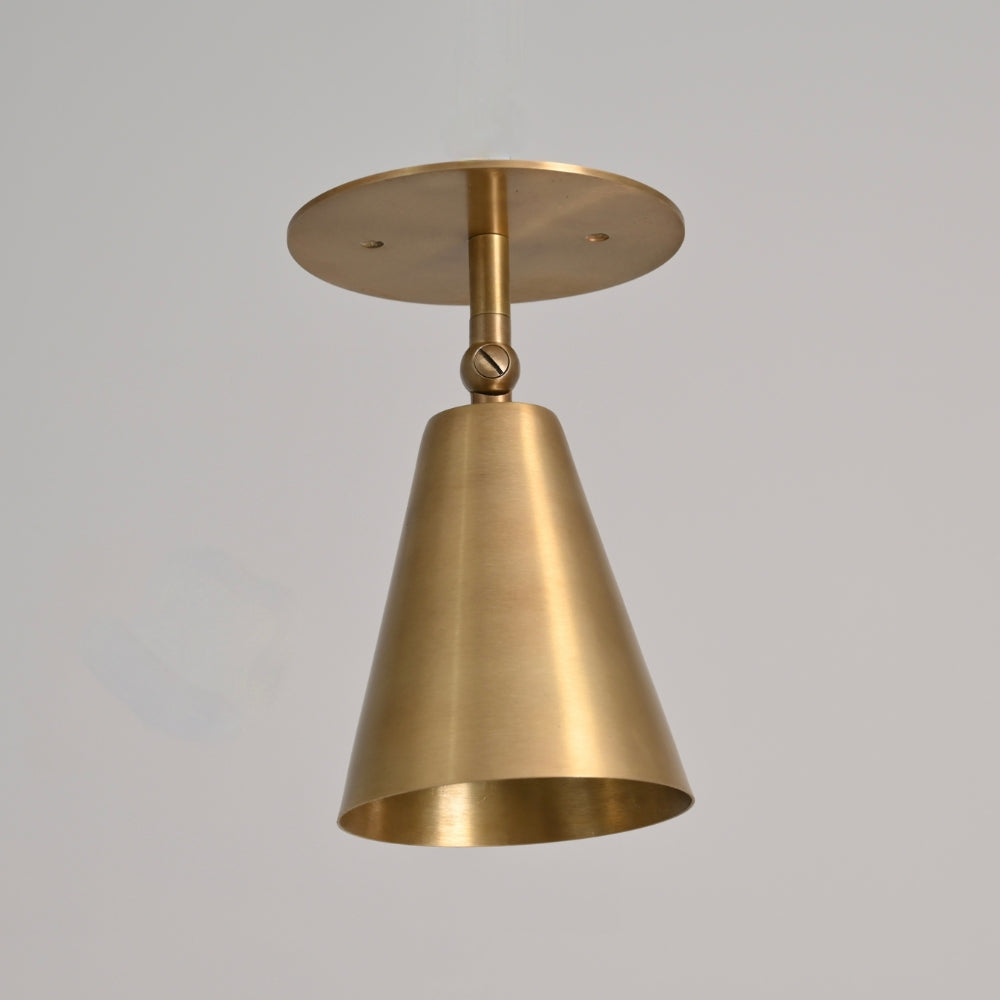 Adjustable wall sconce handcrafted in a pure raw brass finish by LightCove. 