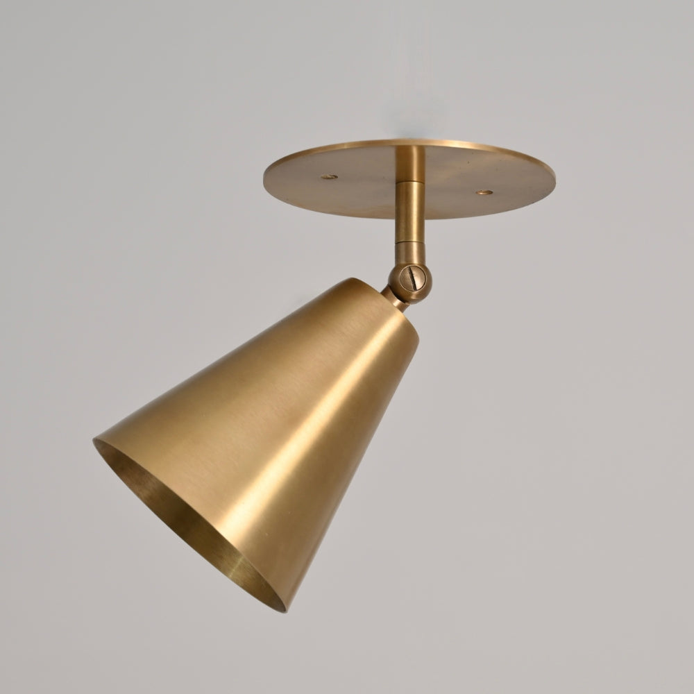 Large cone spot light sconce adjustable shade on a gray background. 